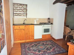 a kitchen with a sink and a stove top oven at Oleander Stone House in Lemona