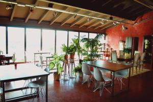 a dining room with tables and chairs and plants at El Lacayo de Sestiello in Grado