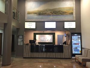 a hotel lobby with a reception desk and a sign at Hotel Castropol in Mexico City