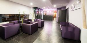 a row of purple chairs in a waiting room at Hotel Eurocentre 3* Toulouse Nord in Castelnau-dʼEstrétefonds
