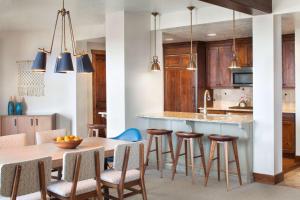 a kitchen that has a table and chairs in it at Hyatt Centric Park City in Park City