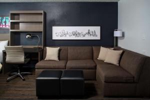 a living room with a couch and a desk at Hyatt House Dallas Uptown in Dallas
