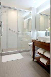 a bathroom with a shower and a sink and a toilet at Hyatt Place Charlotte Downtown in Charlotte
