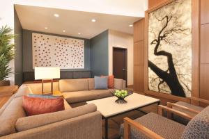 a living room filled with furniture and a painting on the wall at Hyatt Place at Anaheim Resort / Convention Center in Anaheim