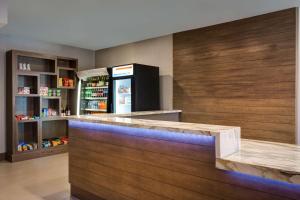 a kitchen with a counter with a refrigerator at Hyatt House Dallas Uptown in Dallas