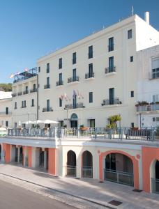 a large white building with a balcony at Grand Hotel Mediterraneo in Santa Cesarea Terme