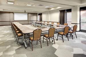 a large conference room with a large table and chairs at Hyatt Place Memphis Primacy Parkway in Memphis