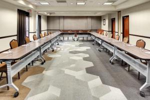 a large conference room with long tables and chairs at Hyatt Place Memphis Primacy Parkway in Memphis