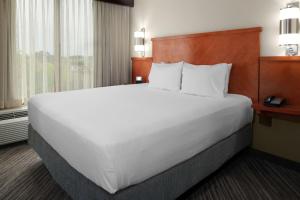 a large white bed in a hotel room at Hyatt Place Memphis Primacy Parkway in Memphis