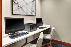 a desk with a computer and a keyboard and monitor at Hyatt Place Memphis Primacy Parkway in Memphis