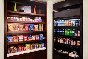 two shelves in a store with food and drinks at Hyatt Place Memphis Primacy Parkway in Memphis