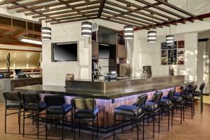 a bar in a kitchen with a bunch of chairs at Hyatt Place Memphis Primacy Parkway in Memphis