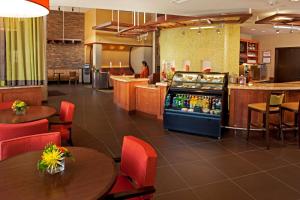 a restaurant with tables and a drink cooler at Hyatt Place Santa Fe in Santa Fe