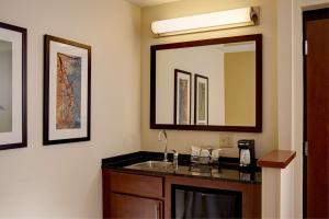 a bathroom with a mirror, sink, and cabinet at Hyatt Place Seattle Downtown in Seattle