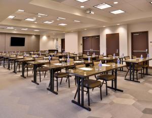 a conference room with tables and chairs and a screen at Hyatt Place Garden City in Garden City +52 photos