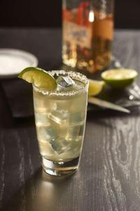 a drink with a lime on a table at Hyatt House Naples 5th Avenue in Naples