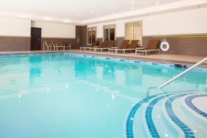 a large pool with blue water in a hotel at Hyatt House Dallas / Frisco in Frisco