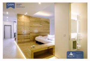a bedroom with a bed and a wooden wall at ORM - Ribeira Apartments in Porto