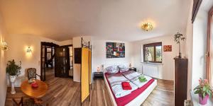 a bedroom with a bed and a table in a room at Ferienwohnung Schulze in Freital