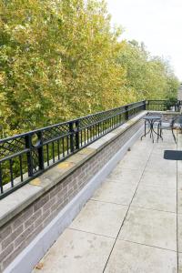 a park bench with two tables and a fence at Penthouse 5 mins walk to City Centre & Colleges with Balcony & Sleeps 6 in Cambridge