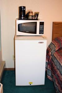a microwave oven sitting on top of a bed in a room at Country Inn Libby in Libby