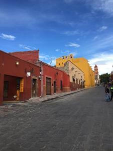 an empty street in a town with colorful buildings at Hotel Galería in San Miguel de Allende