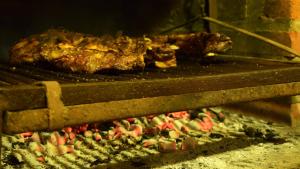 a piece of meat is cooking in an oven at marangatu apart hotel in Puerto Iguazú