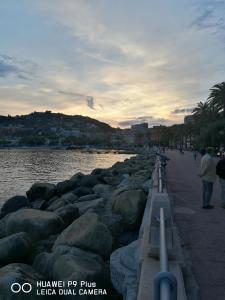 a group of people walking along a pier near the water at Costaguta Apartment in Rapallo