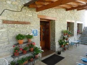 un bâtiment avec des plantes en pot à l'avant dans l'établissement Hotel Esther, à La Virgen de la Vega