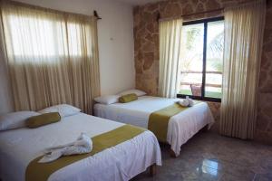 Hotel Villa de Pescadores tesisinde bir odada yatak veya yataklar