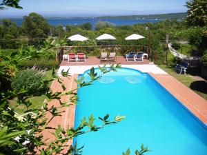 a blue swimming pool with a view of the ocean at Vistas Apart in Embalse
