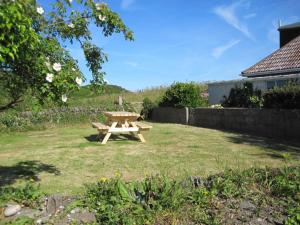 a picnic table in a yard in a field at Old Vicarage Mortehoe Near Woolacombe 2 x sleeps 4 and 1 x sleeps 10 cottages in Mortehoe
