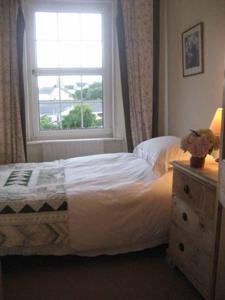 a bedroom with a bed and a window at Old Vicarage Mortehoe Near Woolacombe 2 x sleeps 4 and 1 x sleeps 10 cottages in Mortehoe