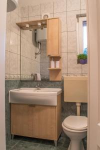 a bathroom with a sink and a toilet at Holiday Home Zdenka in Rogoznica