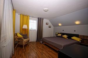 ein Schlafzimmer mit einem Bett, einem Stuhl und einem Fenster in der Unterkunft Cozy Gardens Apartments in Prague in Prag