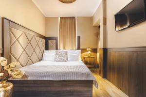 Posteľ alebo postele v izbe v ubytovaní Komló Hotel Gyula
