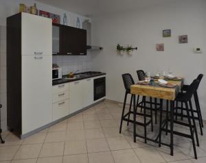 a kitchen with a white refrigerator and a table with chairs at Heart of the city app in Rijeka