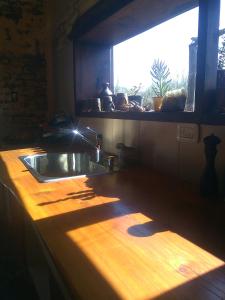 a kitchen counter with a sink and a window at Hogar de Campo in San Rafael