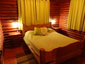 A bed or beds in a room at Las Cortaderas Cabañas de Tronco