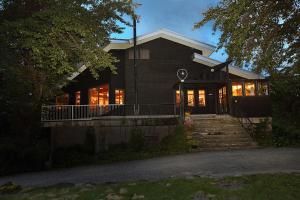 a house with lights on in the night at Momiji in Otari