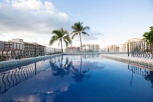 
a swimming pool with a balcony overlooking a beach at Casa Doña Susana in Puerto Vallarta

