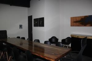 a conference room with a wooden table and chairs at Homesuites Malecon in Culiacán