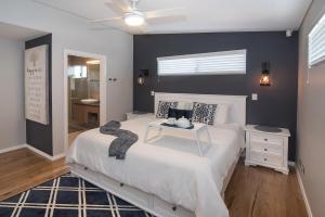 a bedroom with a white bed with a table on it at Busselton Beach House in Busselton