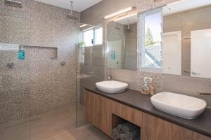 a bathroom with two sinks and a glass shower at Busselton Beach House in Busselton +16 photos