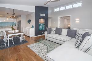 a living room with a couch and a table at Busselton Beach House in Busselton