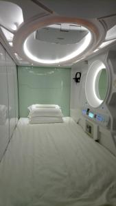 a room with a bed and a round ceiling at Stay With Me Capsules Hostel in Melaka