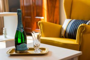 a bottle of champagne and a glass on a table at Engel Apartman in Budapest