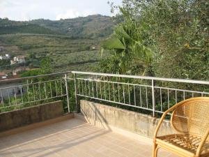 a balcony with a chair and a view of a mountain at La Locanda di Campagna in Agropoli +27 photos
