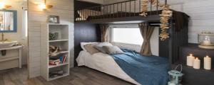 a bedroom with a bed and a window at La Rocca Camping Village in Bardolino