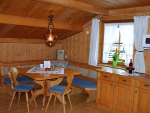 a kitchen with a table and chairs in a cabin at Haus Südblick in Zell am See +48 photos